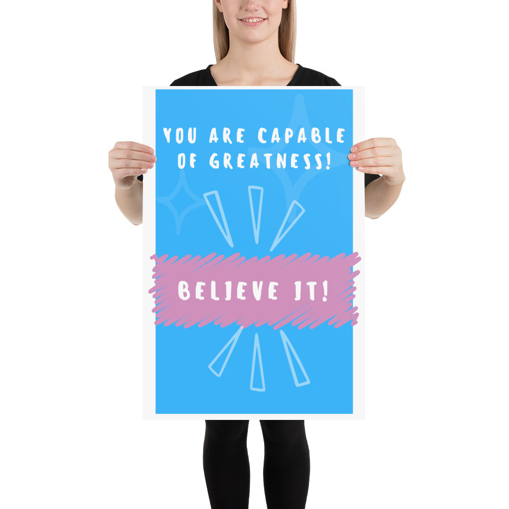 Front facing blue with pink stripe thin canvas wall decor with the phrase, You are capable of greatness! Believe it!. Size 20x30 inches.