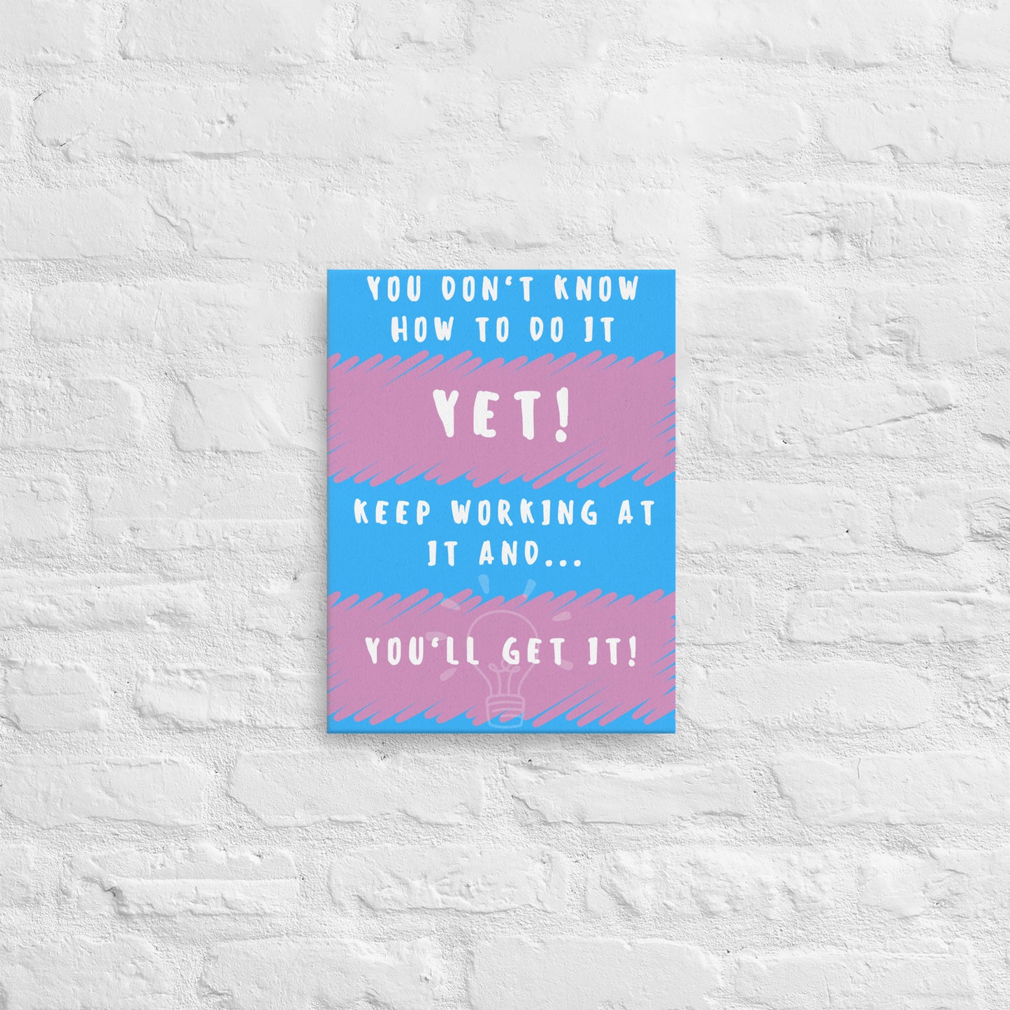 Front facing pink and blue striped thin canvas wall decor with the phrase You don't know how to do it yet! Keep working at it and...you'll get it. Size 12x16 inches.