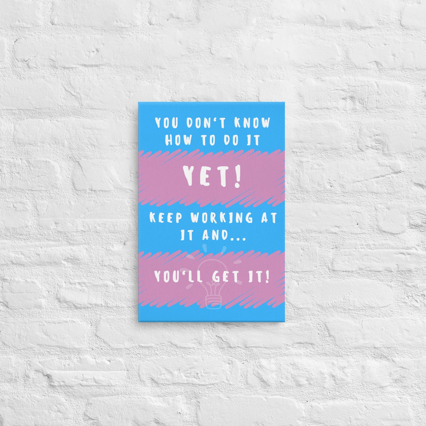 Front facing pink and blue striped thin canvas wall decor with the phrase You don't know how to do it yet! Keep working at it and...you'll get it. Size 12x18 inches.