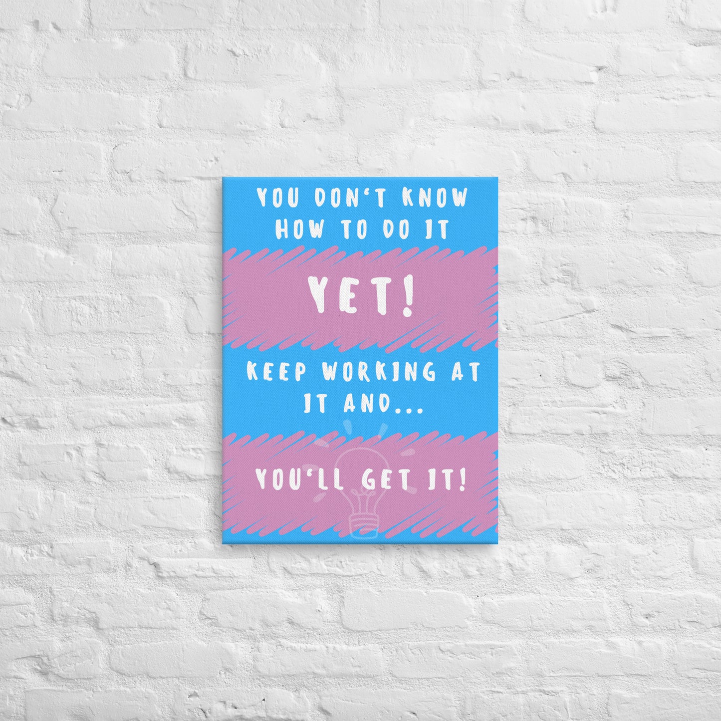 Front facing pink and blue striped thin canvas wall decor with the phrase You don't know how to do it yet! Keep working at it and...you'll get it. Size 18x24 inches.