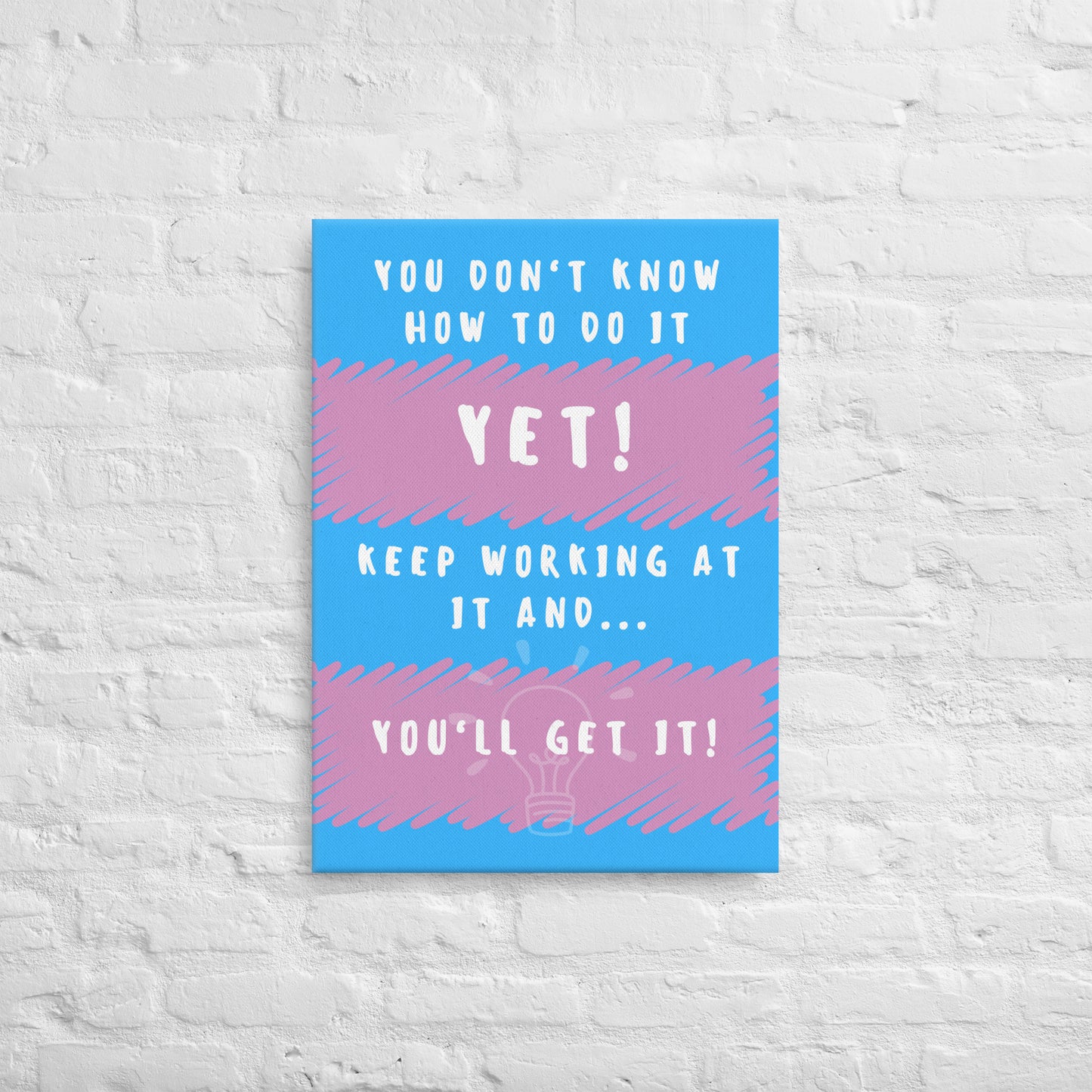 Front facing pink and blue striped thin canvas wall decor with the phrase You don't know how to do it yet! Keep working at it and...you'll get it. Size 20x28 inches.