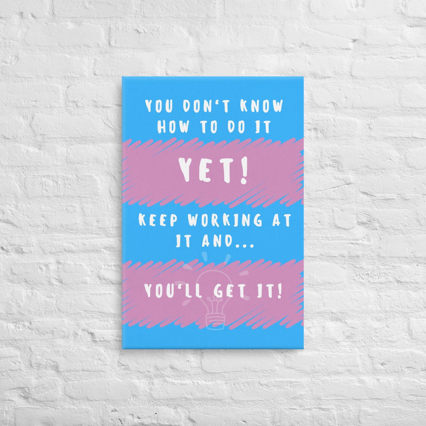 Front facing pink and blue striped thin canvas wall decor with the phrase You don't know how to do it yet! Keep working at it and...you'll get it. Size 20x30 inches.