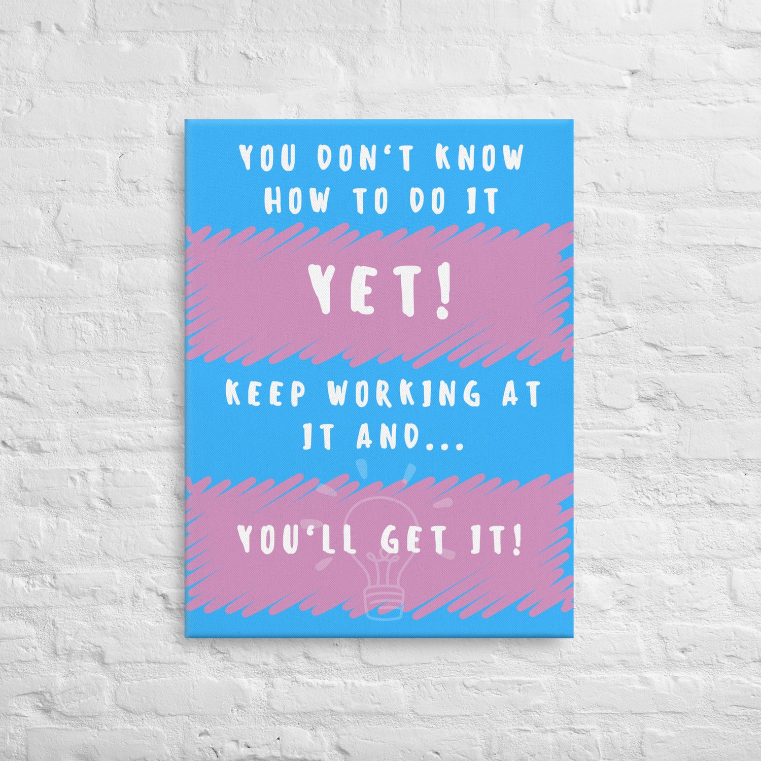 Front facing pink and blue striped thin canvas wall decor with the phrase You don't know how to do it yet! Keep working at it and...you'll get it. Size 24x32 inches.